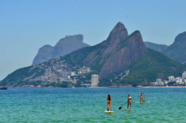 Os praticantes de stand up paddle aproveitam as águas claras do Arpoador Os praticantes de stand up paddle aproveitam as águas claras do Arpoador
