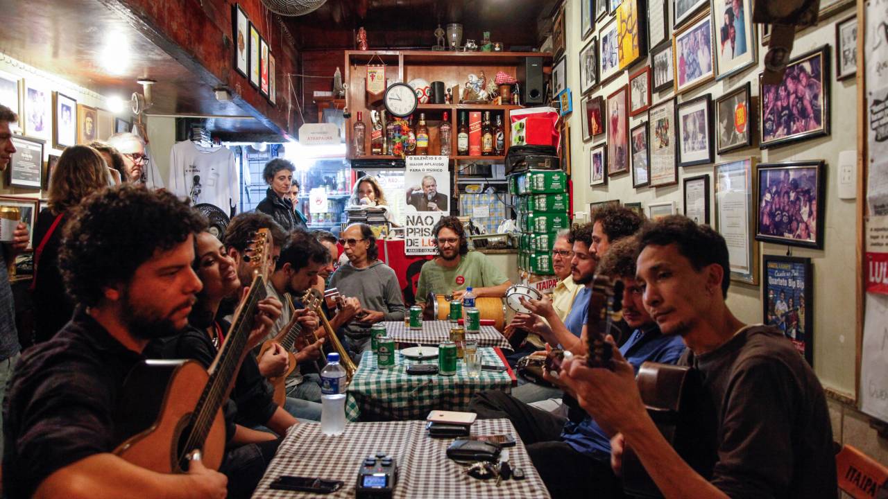 Roda de samba em torno das mesas do bar Bip Bip