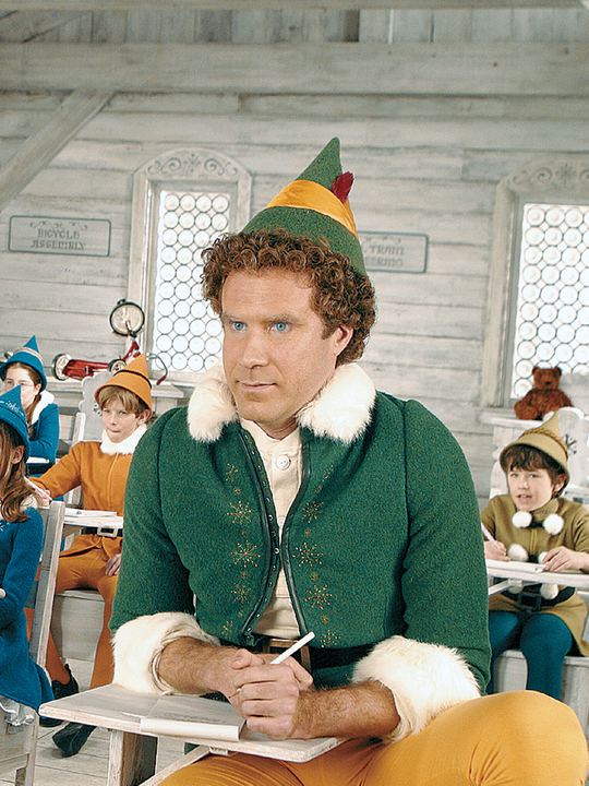 Will Ferrel vestido como duende numa sala de aula com outras crianças