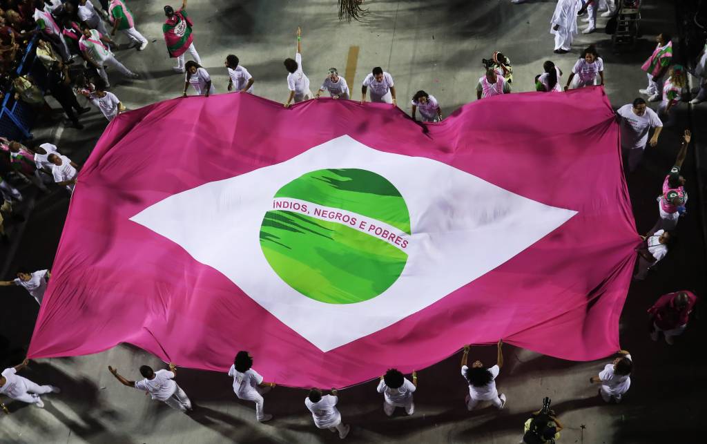 Desfile da Mangueira em 2019, em que integrantes desfilaram sob bandeira do Brasil em verde e rosa com os dizeres índios, negros e pobres