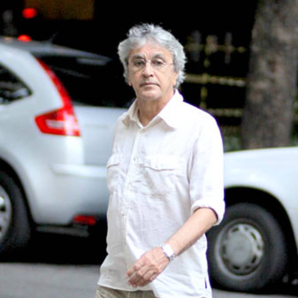 A imagem mostra Caetano Veloso andando por uma rua do Leblon
