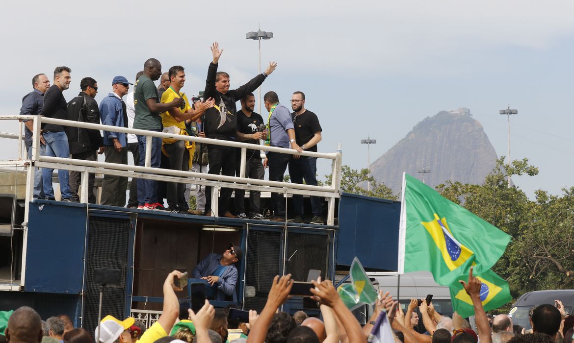 A imagem mostra o presidente Jair Bolsonaro sem máscara, em cima de um carro de som