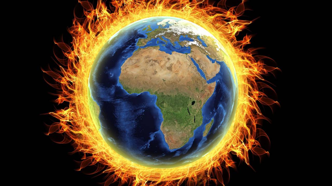 A imagem mostra o globo terrestre circundado por fogo, representando a mensagem do aquecimento global
