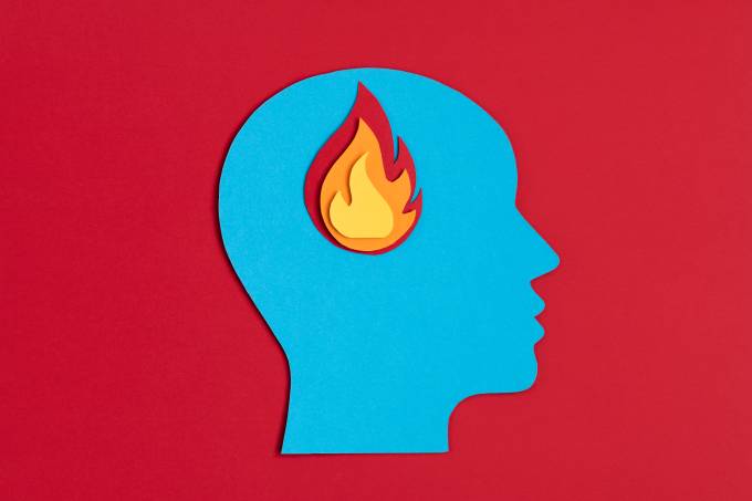 Papercut head with fire inside. Mental health problems, burnout, psychology, stress, mental illness