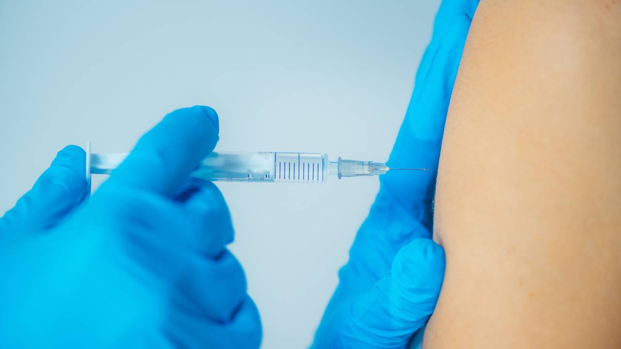 Uma injeção sendo aplicada em um braço.