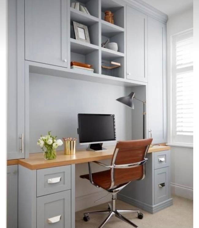 Home Office A imagem mostra um home office. Em primeiro plano uma estante com mesa e em segundo plano uma cadeira de trabalho.