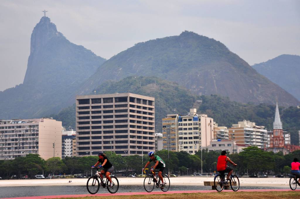 Imagem mostra ciclistas andando de bike na Praia de Botafogo