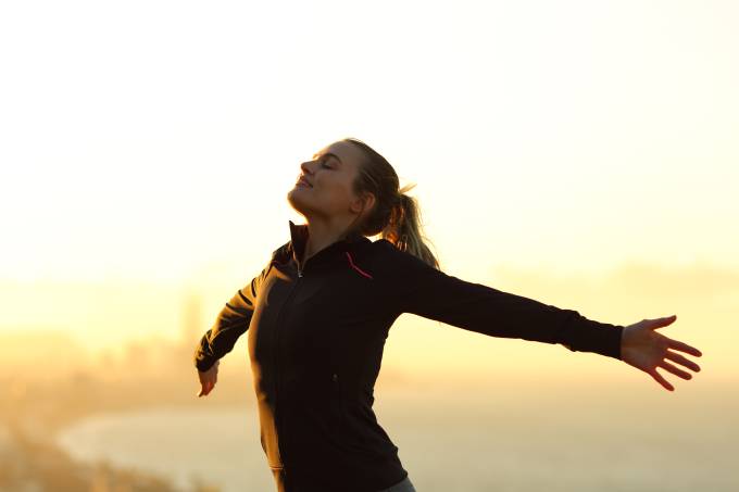 Happy,Runner,Breathing,Fresh,Air,Outstretching,Arms,At,Sunset,In