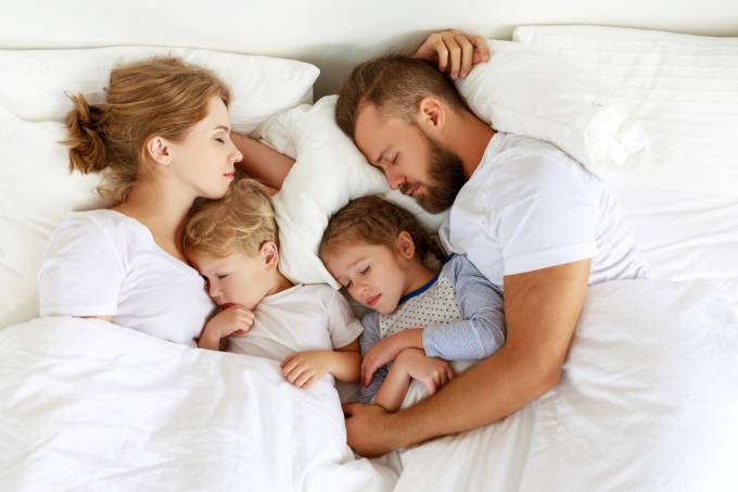 Healthy,Sleep.,Happy,Family,Parents,And,Children,Sleeping,In,White