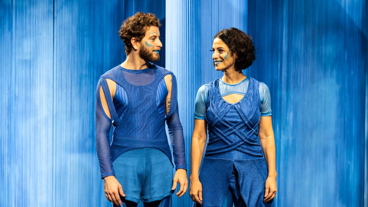 Foto mostra atores usando roupas azuis no palco